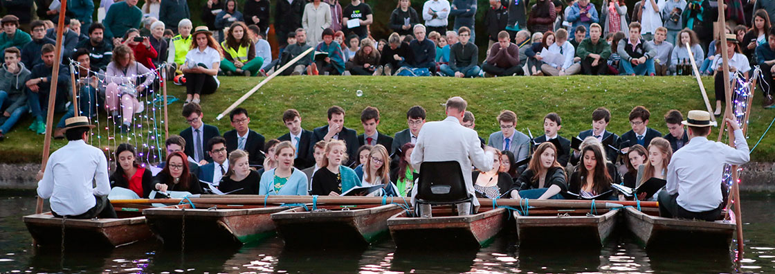 Students singing on river